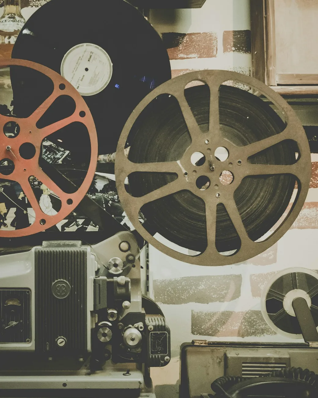 A collection of vintage film reels and projection equipment.