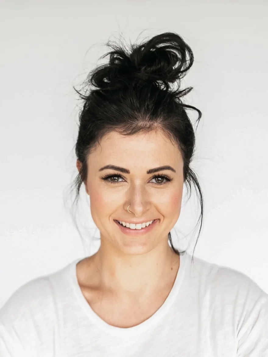 Studio portrait against a pale backdrop, looking directly at the camera.